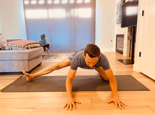 Physical therapist demonstrating inner thigh stretch 