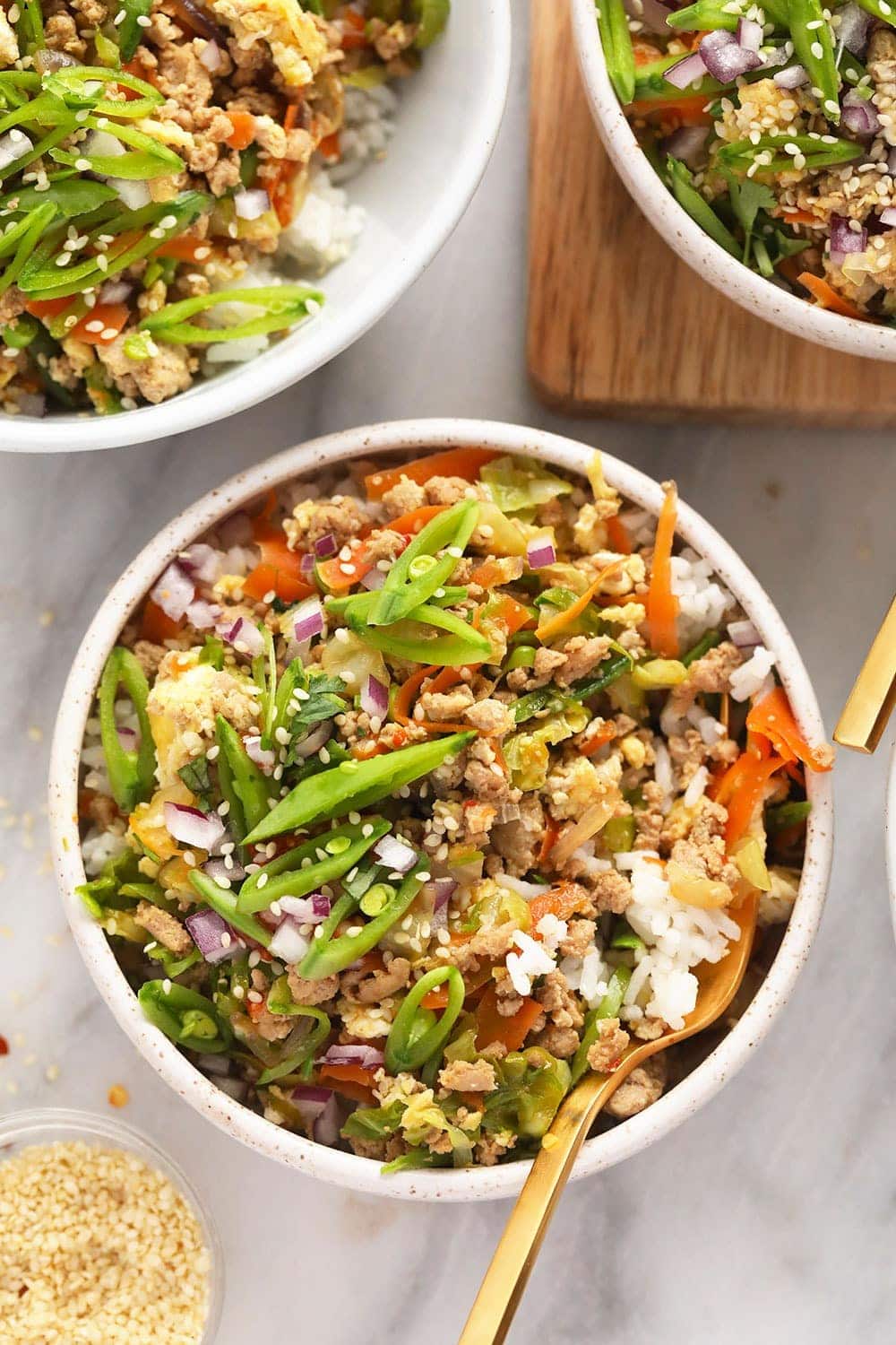 This vibrant Egg Roll in a Bowl recipe is packed with all the flavors you love in traditional egg rolls, but is deconstructed and served in a bowl for a healthy and delicious alternative. No deep frying! egg roll in a bowl served with rice