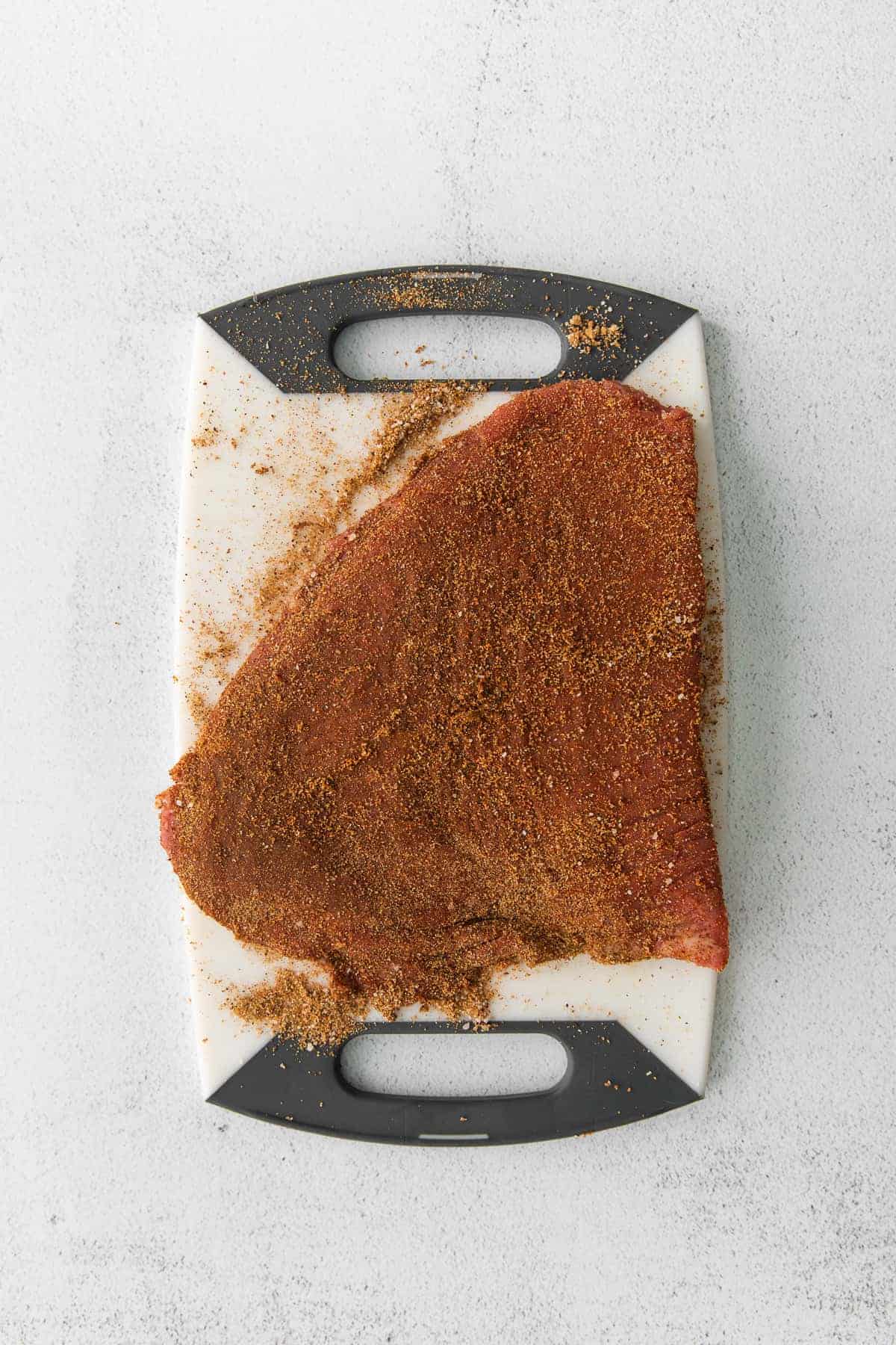 This super flavorful steak taco seasoning comes together in just 7 ingredients you likely have on hand in your spice cupboard already. flank steak with steak taco seasoning dry rub on it