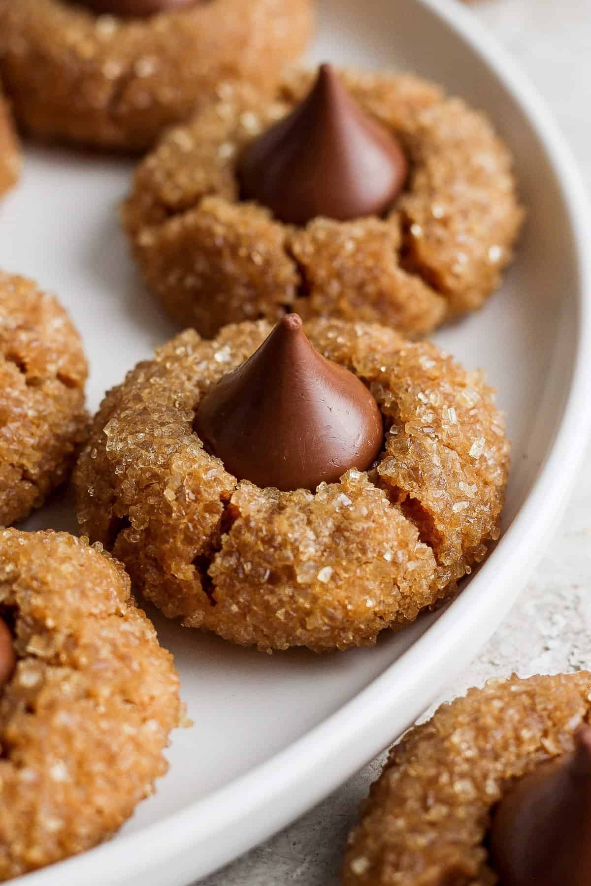 Peanut butter cookies with chocolate kisses on a plate.