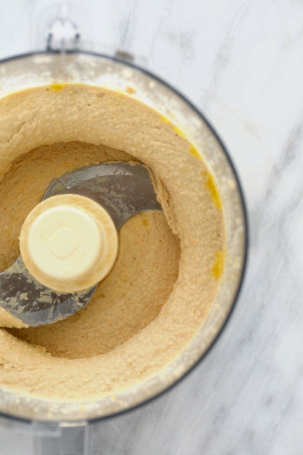 All those hummus flavors you love with a lemon garlic twist! Make this healthy lemon garlic hummus and get ready for all your dip dreams to come true. lemon garlic hummus in a food processor