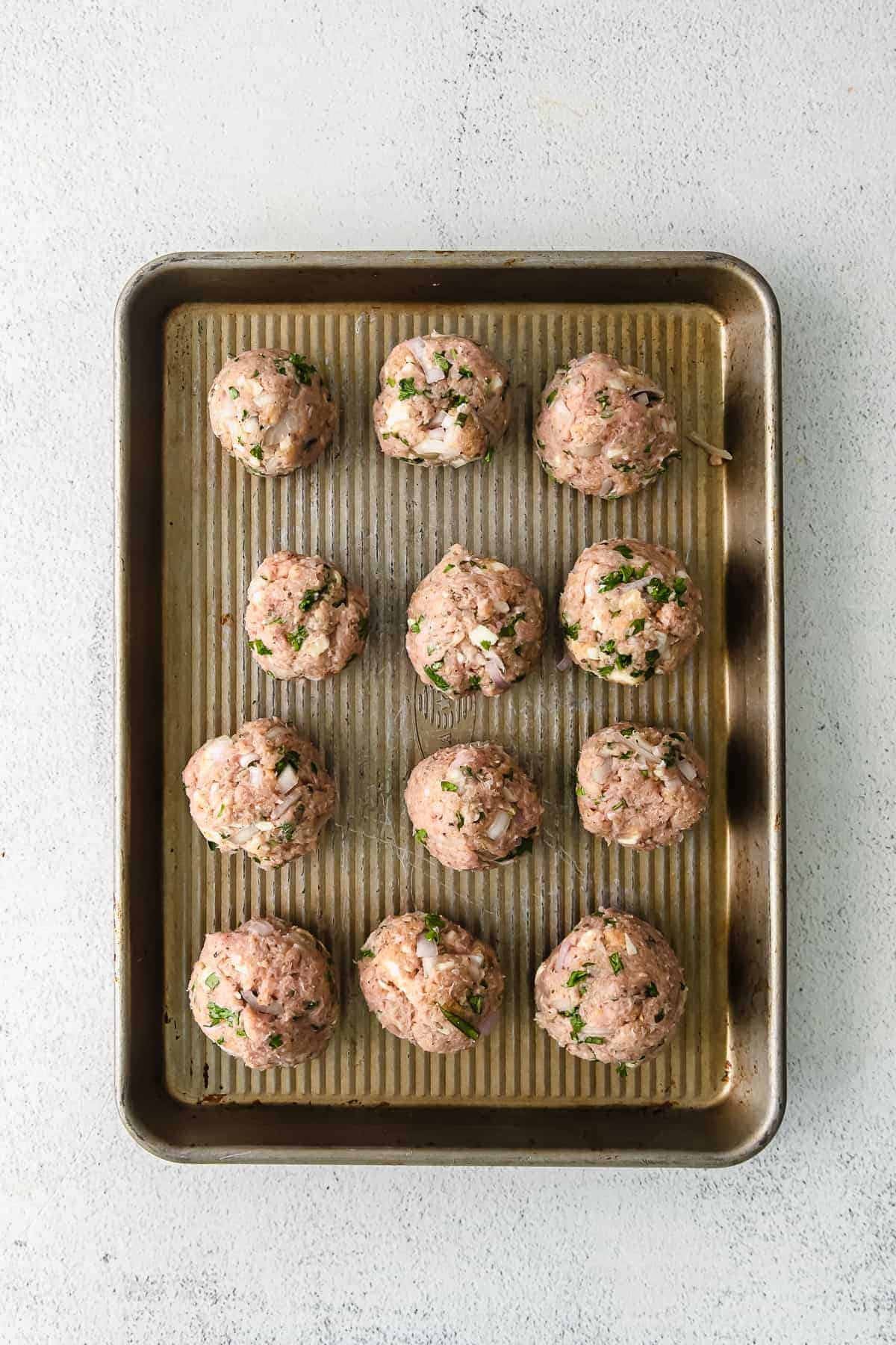 Meatballs on a baking sheet.