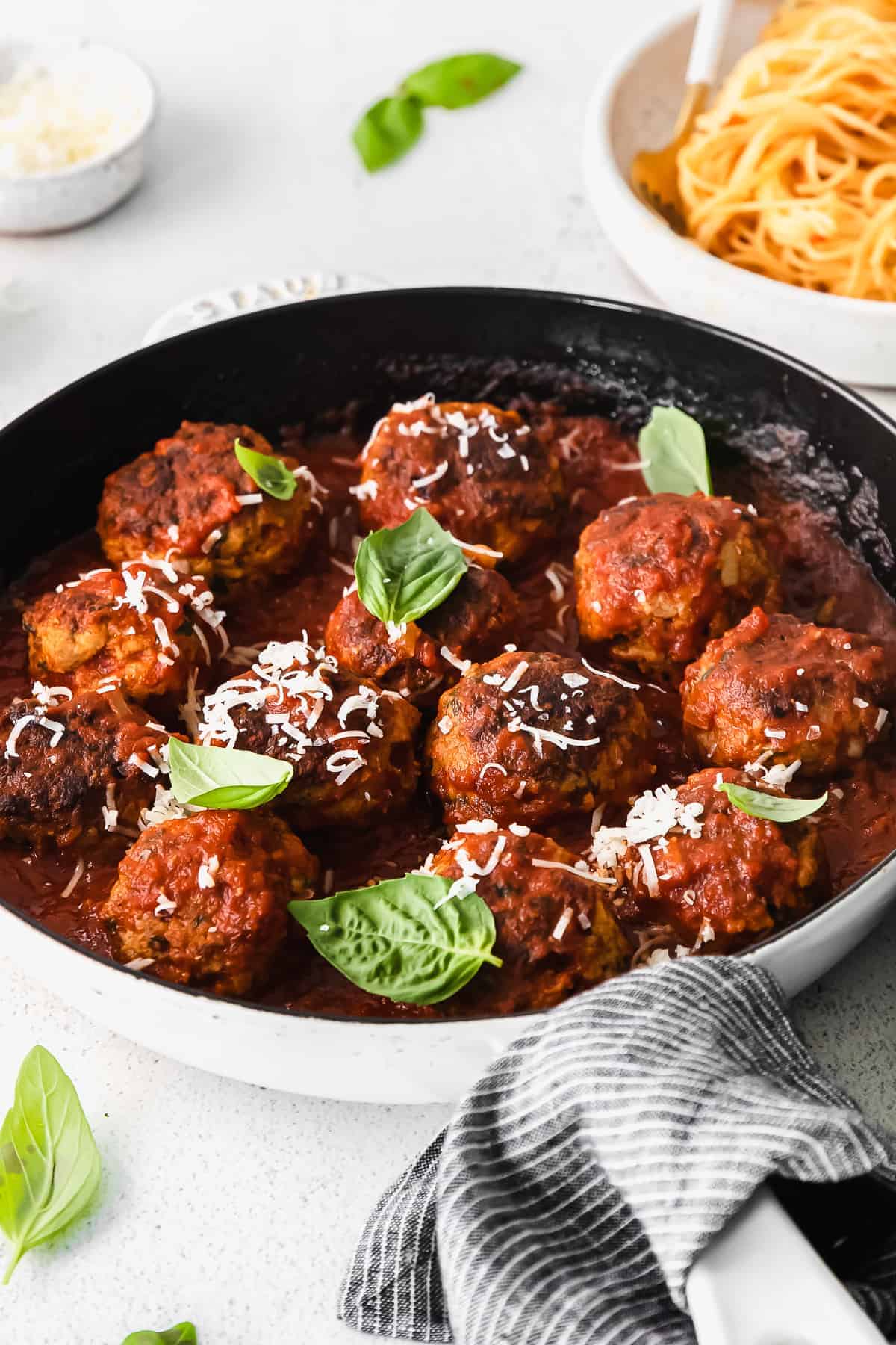 Meatballs in tomato sauce in a skillet.