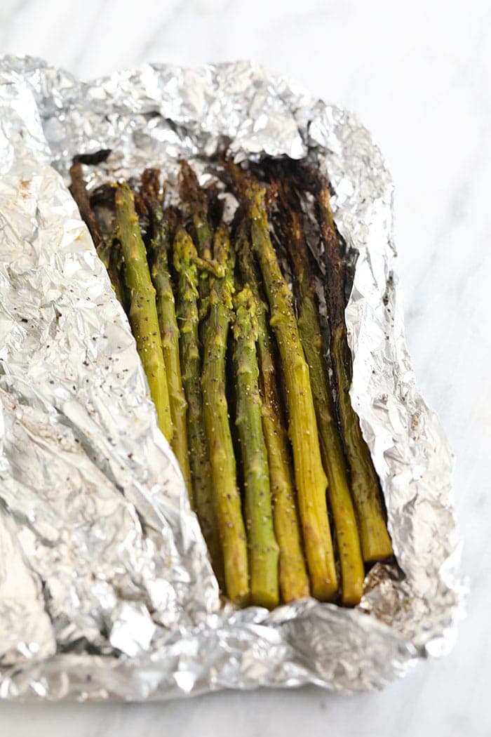 perfectly grilled asparagus in an opened foil packet