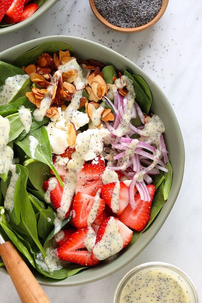 Meal prep this strawberry spinach salad for easy, healthy lunches all week Strawberry spinach salad in a bowl topped with feta and candied almonds.