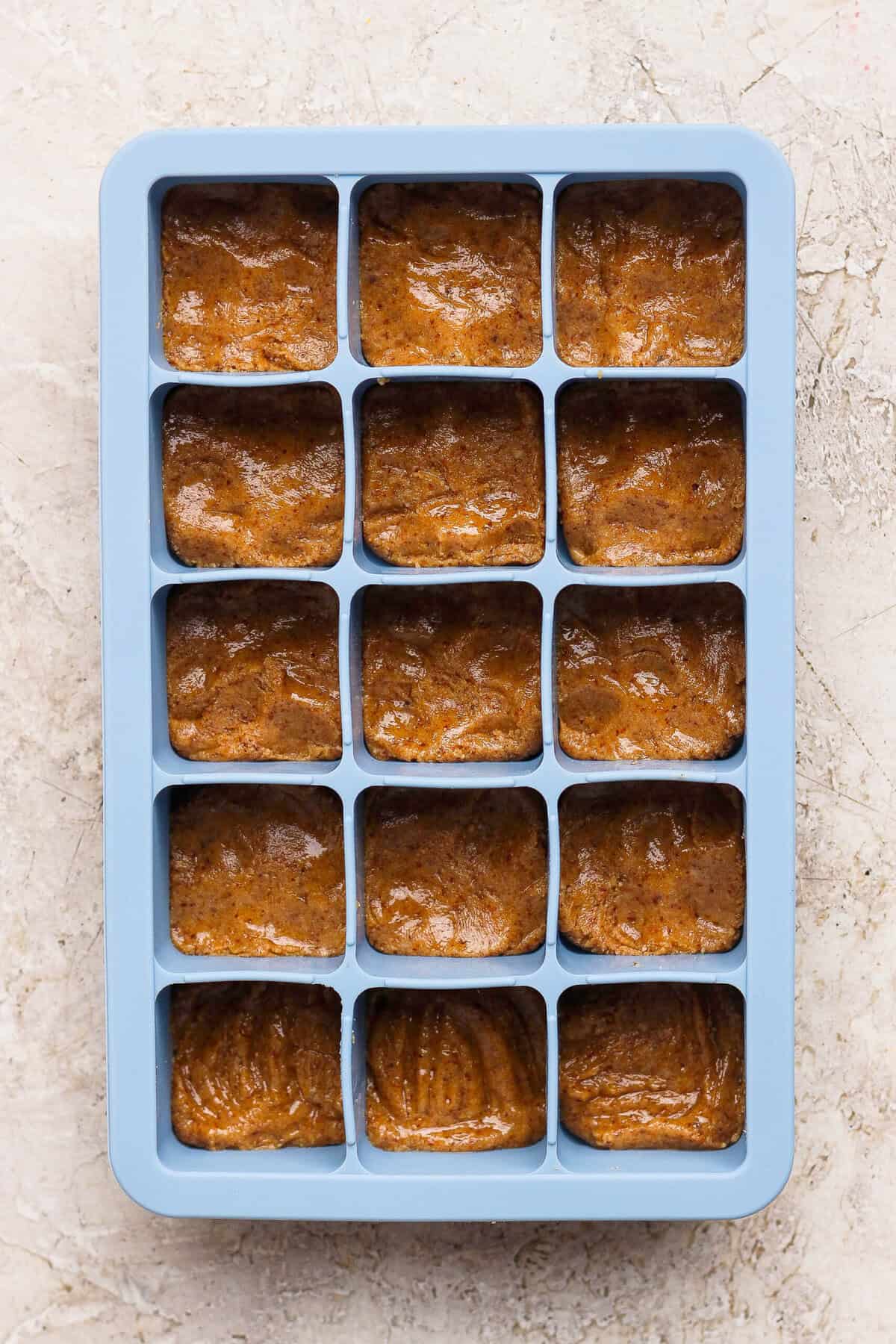 thin mint protein bite base pressed flat into a blue silicone ice cube tray