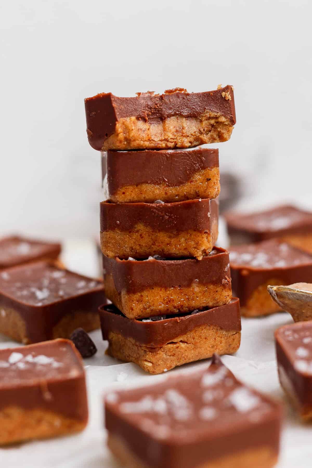 stacked thin mint protein bites with a bite taken out showing fudgy interior texture