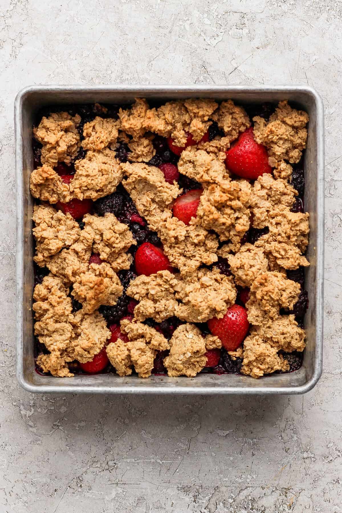 golden brown protein berry crumble fresh out of the oven in a baking pan