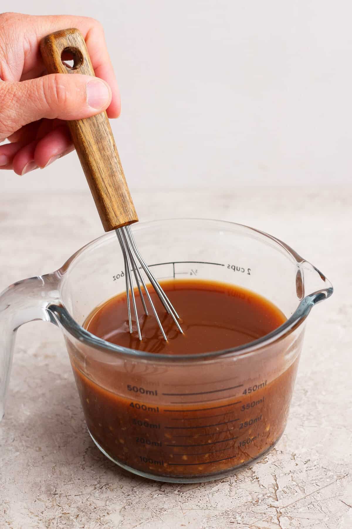 Whisking hoisin, soy sauce, garlic, and ginger together for cashew chicken casserole sauce.