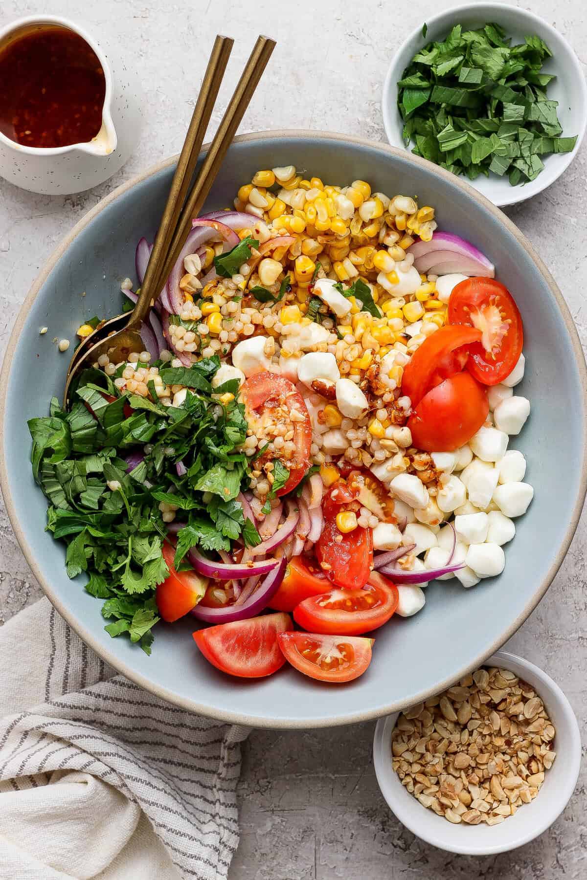 finished corn tomato salad with mozzarella pearls corn and tomatoes styled with peanuts and dressing