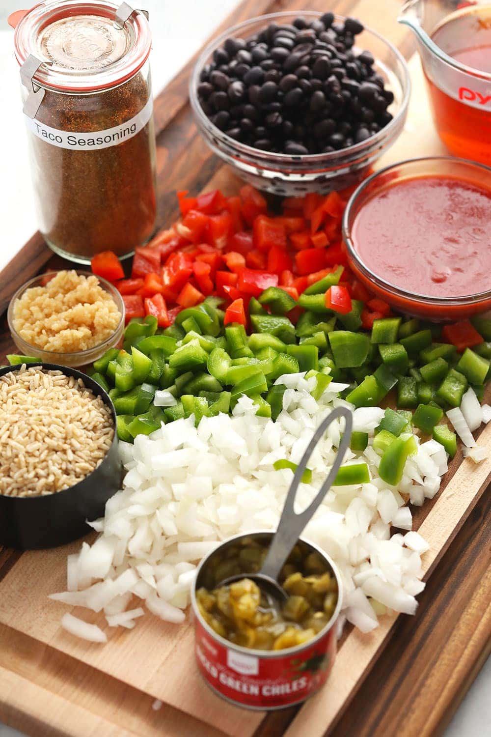 Whether you make this on game day or eat it as a main meal, this Mexican Beef Skillet requires one pan only and only 40 minutes of your time! ground beef skillet ingredients on cutting board.