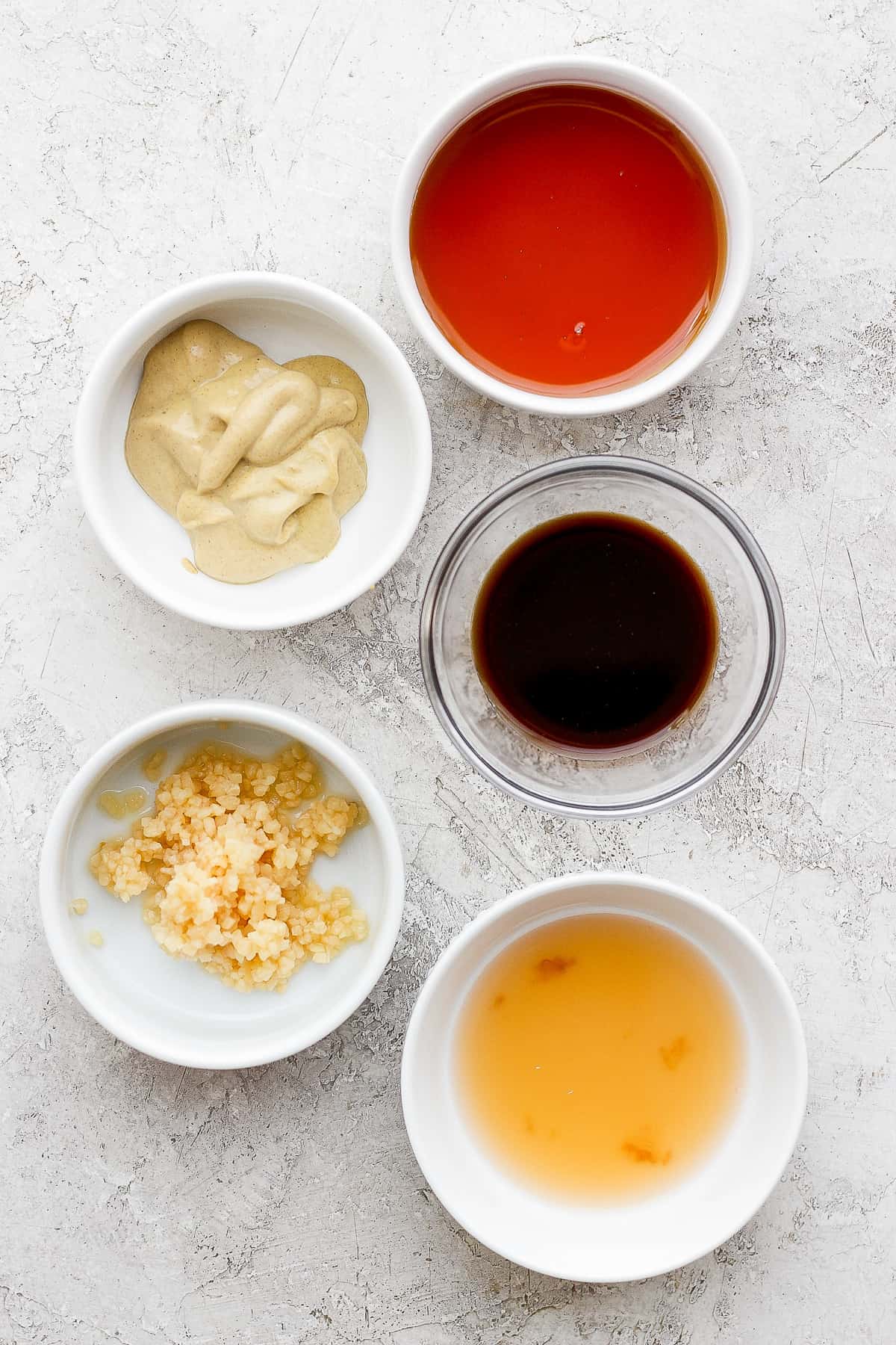 This classic rib marinade recipe is perfectly savory and sweet with only 5 ingredients -- an amazing complement to your baby back ribs. Enjoy! Rib marinade ingredients in bowls.