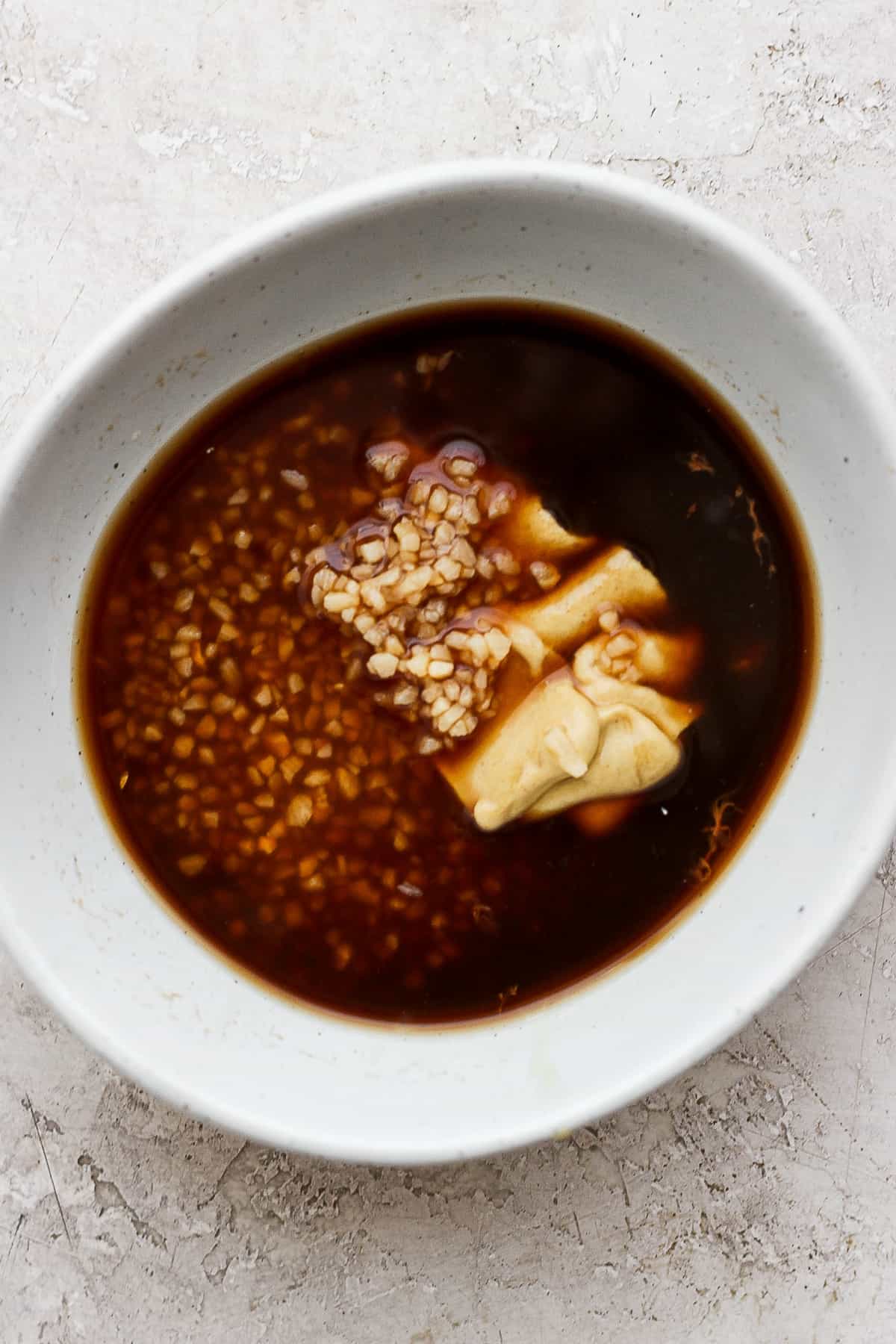 This classic rib marinade recipe is perfectly savory and sweet with only 5 ingredients -- an amazing complement to your baby back ribs. Enjoy! Rib marinade ingredients in a bowl.