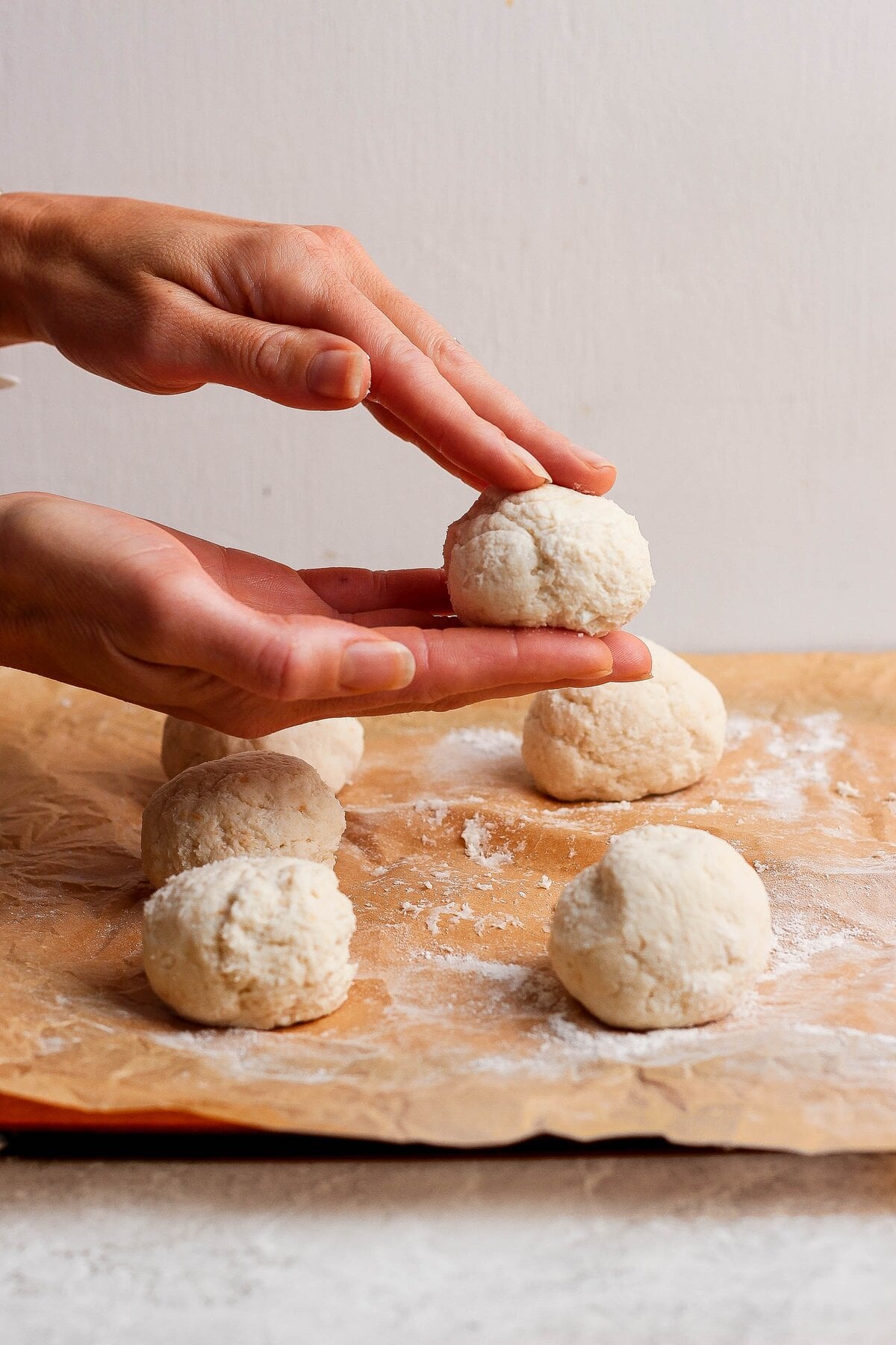 Cottage cheese dough divided into individual balls before shaping the Danish wells.