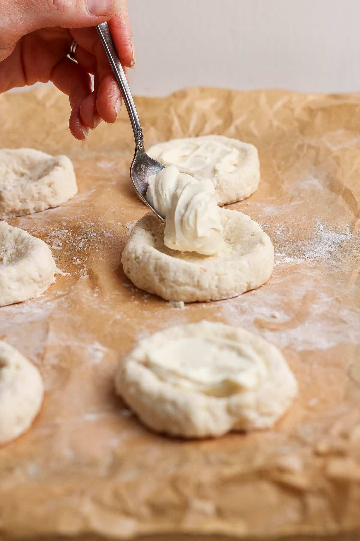 Creamy cottage cheese and cream cheese filling spooned into a well in the dough.
