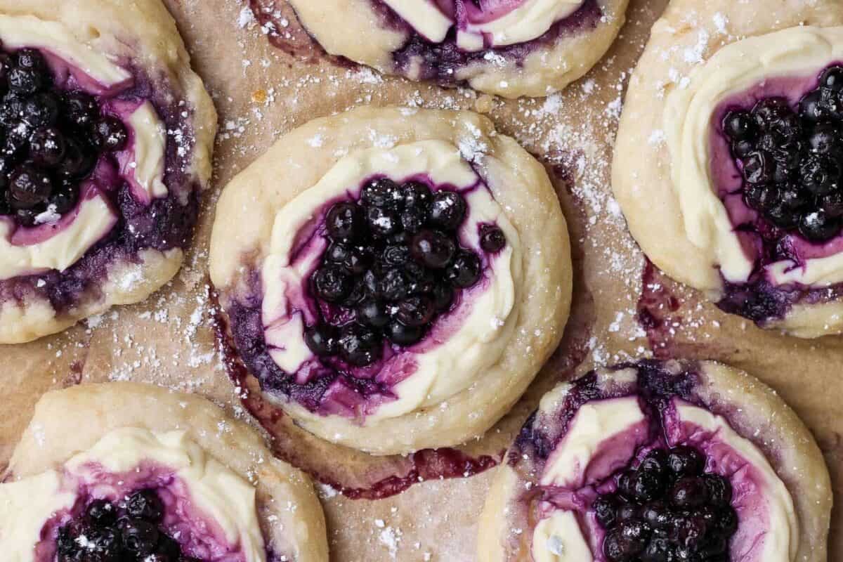 Overhead view of blueberry cottage cheese Danish with wild blueberries and powdered sugar.