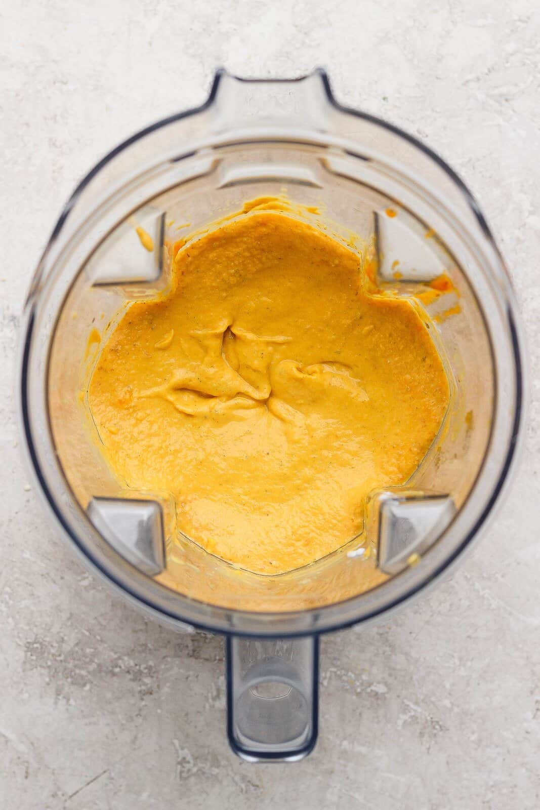 Smooth orange pumpkin and cottage cheese pasta sauce in a blender.